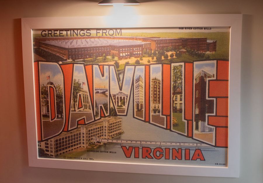 Oversized “Greetings from Danville, Virginia” vintage postcard print framed in a hallway