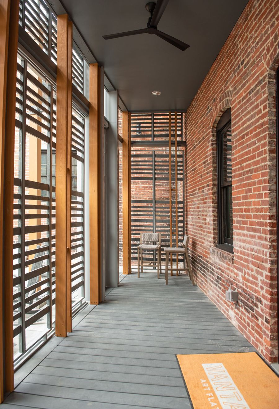 Covered private porch with louvered screens and bistro seating