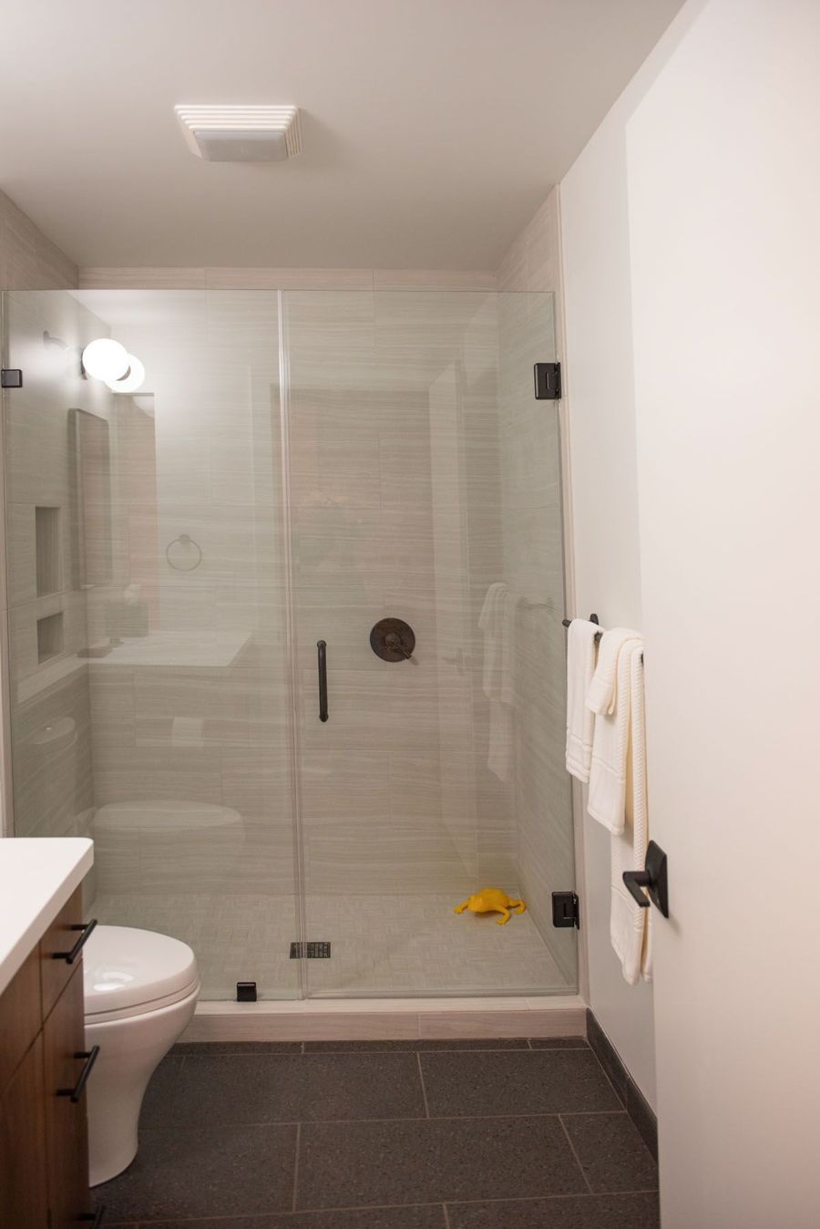 Bathroom with a glass walk-in shower and wood vanity