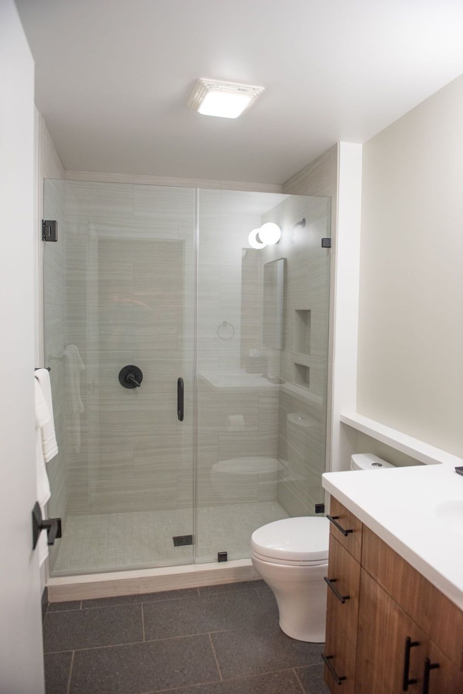Bathroom with a glass walk-in shower and sapele wood vanity